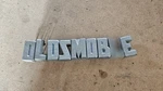 Selling Each 1957 Oldsmobile 88 98 Grille Script Letter 2ND Type Used. Price: $39.00.