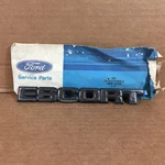 Nos Oem Ford 81 82 83 84 85 86 E1FZ-6142528-E "escort" Trunk Name Plate New. Price: $15.00.